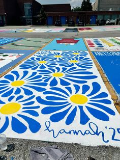 the sidewalk is decorated with blue and yellow flowers