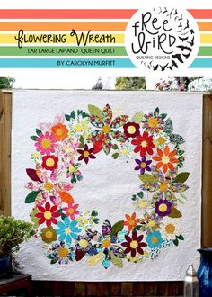 a white quilt with colorful flowers on it