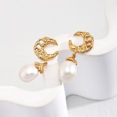 The focal point of these earrings is the intricately crafted moon design, made from high-quality sterling silver and plated with luxurious gold. The moon symbolizes beauty and mystery, and its delicate shape adds a touch of celestial charm to the earrings. The gold plating enhances the elegance of the design and lends a warm, radiant glow.  Dangling from the moon are lustrous freshwater pearls, carefully selected for their iridescent beauty and organic shape. Each pearl exhibits a unique blend o Natural Pearl Earrings, Sky Stars, Luna Moon, Pearl Dangle Earrings, June Birthstone Jewelry, Freshwater Pearls Earrings, Gold Moon, Pearl Jewellery Earrings, Pearl Set