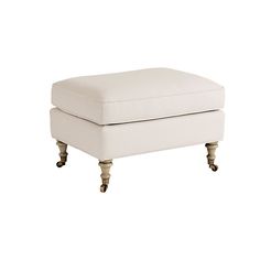 a white foot stool with wheels on it