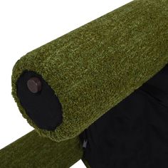 the back end of a green and black chair with its cover pulled up to it's side