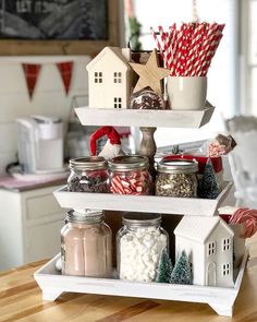 three tiered tray with candy and candies in jars on top of each other