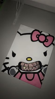 an image of a hello kitty painting on the wall with glitter eyes and pink hair