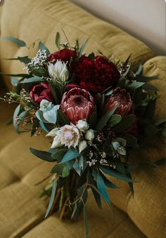 a bouquet of flowers sitting on top of a couch