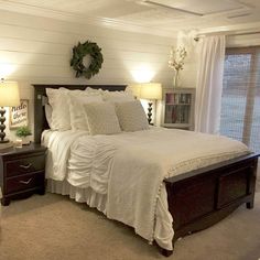 a large bed sitting in a bedroom next to two lamps