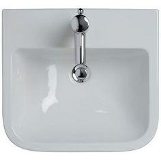 a white sink with chrome faucet and soap dispenser