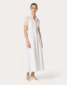 Daisy Organdis Midi Dress - Concealed front button fastening - Daisy Organdis (93% Cotton, 7% Polyester) - Muslin lining (100% Cotton) - Length: 130 cm / 51.1 in. from the shoulders in an Italian size 40 - Sleeve length: 45 cm / 17.7 in. from the centre back in an Italian size 45 - The model is 176 cm / 5'9" tall and wears an Italian size 40 - Made in Italy The look of the model is completed by a Valentino Garavani VLOGO MOON Bag and Valentino Garavani The Bold Edition Shoes. Luxury White Dress With Buttons, White Formal Dresses With Button Closure, Luxury Spring Dresses With Button Closure, Spring Luxury Dresses With Button Closure, White Workwear Dresses With Covered Buttons, Elegant Short Sleeve Dresses With Covered Buttons, Luxury White Daywear Dress, Summer Formal Midi Dress With Covered Buttons, Formal Summer Midi Dress With Covered Buttons