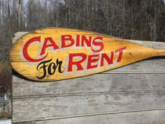 a wooden sign that says cabins for rent