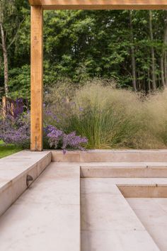 an outdoor area with steps and flowers in the background