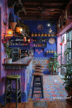 the interior of a colorfully decorated restaurant with stools