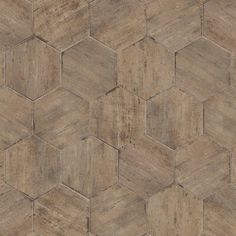 a wooden floor with hexagonal tiles in brown and beige colors, as well as the