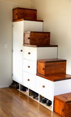 the stairs are made from wood and have drawers under them