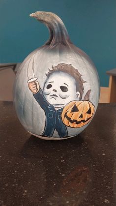 a painted pumpkin with a child's face on it