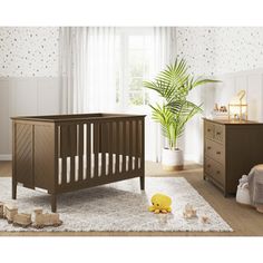 a baby's room with a crib, dresser and bed