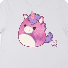 Hang out with your favorite unicorn with this Squishmallows tee. The shirt features an image of Lola the Unicorn sitting next to purple letters that spell out her name. The tee comes in a white short sleeve crew neck. Squishmallows fans will love this comfy cotton t-shirt. Purple Graphic Print Kawaii T-shirt, Purple Kawaii T-shirt With Graphic Print, Kawaii Purple T-shirt With Graphic Print, Cute White T-shirt With Unicorn Print, Purple Crew Neck T-shirt In Kawaii Style, Casual White T-shirt With Unicorn Print, Purple Cartoon Print Fun T-shirt, Purple Short Sleeve Kawaii T-shirt, Purple Kawaii Short Sleeve T-shirt