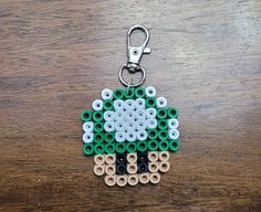 a keychain made out of legos on top of a wooden table