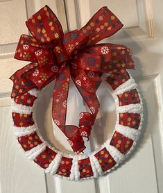 a red and white wreath with snowflakes on it