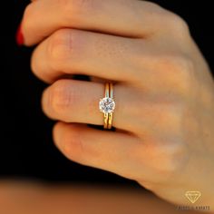 a woman's hand with a diamond ring on it