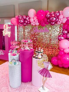 a pink and gold birthday party with balloons, cupcakes, cake and decorations