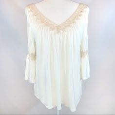 G Collection Size S Ivory Boho V-Neck W Lace Cutout 3/4 Bell Sleeve Tie Blouse V-Neck Front & Back W Crocheted Lace Trim Open V-Neck Back Ties At Top 3/4 Bell Sleeves Have Openening On Sides At Top W Tan Crocheted Lace At Elbow Loose Flowy Fit W Ruching At Top Rounded Hemline Soft Comfy Rayon/Spandex Blend Stretch Knit Fabric Excellent Nwot Condition!! Lno Flaws! Pit To Pit 22” Length From Shoulder 27” Sleeve Length 17” A0215 White Tops With 3/4 Sleeve And Lace Trim, Cream V-neck Blouse For Brunch, White Half Sleeve Blouse For Brunch, Feminine White Half-sleeve Blouse, Feminine White Half Sleeve Blouse, Off White V-neck Top For Brunch, White Bohemian Half Sleeve Tops, Chic Cream Blouse With 3/4 Sleeves, Bohemian Cream Blouse With 3/4 Sleeves