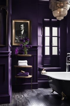 a bath room with a tub and a painting on the wall