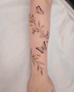 a woman's arm with butterflies on it