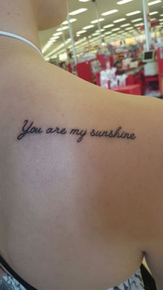 the back of a woman's shoulder with an inscription on it that says, you are my sunshine