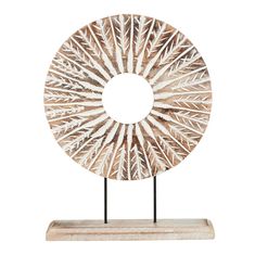 a white and brown sculpture on a stand with a circular mirror in the middle of it