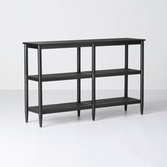 a black shelf with three shelves on each side and one shelf below the shelf is empty