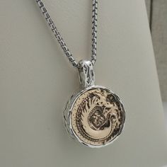 "Sterling Silver with Bronze Large Dragon Spirit Pendant Dragon Coin Pendant with Celtic Knot on side and back Dragon  pendant 7/8\" x 1.25\" Long  Side depth measures 7 mm  22.7 grams pendant and chain. 22\" Venetian Box Chain (Can substitute 16\", 18\" or 20\") This pendant is inspired by ancient Celtic coinage late 2nd/ 1st c. BC. Petrichor Dragon Spirit Pendant by Keith Jack Gift boxed with cleaning cloth. Imported from Canada. Ships in 3 to 5 days. (Selecting alternative chain length may de Collectible Round Pendant Box Chain Jewelry, Sterling Silver Medallion Jewelry With Box Chain, Sterling Silver Round Box Chain Jewelry, Luxury Silver Jewelry With Coin Pendant, Sterling Silver White Gold Coin Pendant Jewelry, Luxury Oxidized Finish Jewelry For Gift, Luxury Oxidized Finish Jewelry For Anniversary, Antique Silver Jewelry With Box Chain, Luxury Round Jewelry Stamped 925