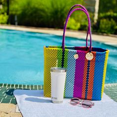 "This beautiful tote is 100% handwoven in Oaxaca, Mexico using a durable  plastic tread. Water-resistant and bendable, these amazing bags look good all year round and are built to last a lifetime!! Perfect for the beach, pool parties, camping, weekends, picnics, college, laptops, farmer's market, books...anything!Approximately Measurements Length: 14\" Height: 12\" Width: 6\" Straps extend 11\" for the long model. Includes magnetic snap closure and interior zippered pocket" Multicolor Rectangular Beach Bag For Poolside, Multicolor Rectangular Bag For Poolside, Multicolor Rectangular Poolside Bag, Reusable Tote Beach Bag, Multicolor Recyclable Beach Bag For Vacation, Summer Beach Bags Made Of Recycled Plastic Bottles, Beach Woven Bags From Recycled Plastic, Beach Bags Woven From Recycled Plastic Bottles, Beach Bag Made Of Woven Recycled Plastic