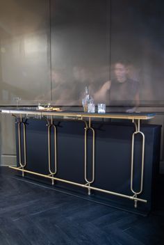 a man sitting at a bar with drinks on it