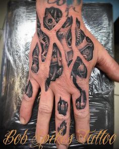 a person's hand with tattoos on it