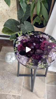 a glass table with purple flowers on it