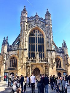 many people are standing in front of an old building