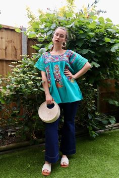 Handmade Chanelito Top - Extra Large /UK16 Measurements: 73cm/28inch Long  breast armpit to armpit 57cm/22.5inch Colour: Turquoise Model Size: Medium / 8 UK Model height: 5'6 This lovely Mexican floral design blouse has been hand-embroidered, ideal at any time of the year perfect for a romantic date, picnic, Mexican Party, Catrina costume or any occasion, This beautiful top is made 100% cotton, made in Puebla, Mexico. Features: Handmade with Love: Each Chanelito top is meticulously crafted by sk Bohemian Green Tops With Embroidered Hem, Bohemian Green Embroidered Top For Festival, Green Tops With Intricate Embroidery For Summer, Summer Green Tops With Intricate Embroidery, Green Embroidered Top For Summer, Green Bohemian Embroidered Top For Festival, Bohemian Green Blouse With Intricate Embroidery, Blue Embroidered Top With Resham For Summer, Embroidered Green Top For The Beach