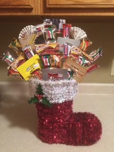 a christmas stocking made out of candy bars and tinsel is sitting on the counter