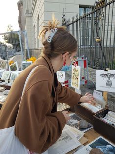 a woman is looking at pictures on a table