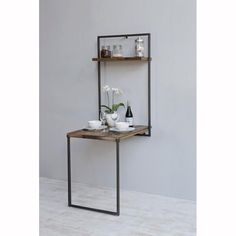 the shelf is made out of metal and has two shelves on each side, with flowers in vases