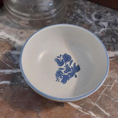 a blue and white bowl sitting on top of a marble counter