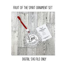 the fruit of the spirit ornament set is shown on a wooden floor with a red toothbrush