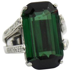 A split-shouldered platinum ring set with 32 round brilliant cut diamonds for a total approximate weight of 0.75ct. The center stone is a beautifully balanced, emerald cut, green tourmaline weighing 22.15ct. The ring is Size 6 with a size by spring inside. Gross weight 27.33 grams. Victorian Diamond Ring, Classic Diamond Ring, Gold Diamond Watches, Emerald Cut Diamond Ring, Three Stone Diamond Ring, Platinum Diamond Rings, Emerald Cut Rings, Round Diamond Ring, Diamond Jewelry Designs