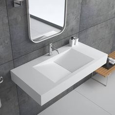 a white sink sitting under a bathroom mirror next to a wooden bench and wall mounted soap dispenser