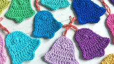 many crocheted hearts are hanging from strings