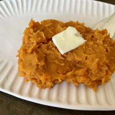 a white plate topped with sweet potatoes and butter