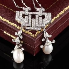 Dazzling diamond necklace with cultured pearls dangling from pendant and on chain.Item #JP-N0025Metal: 18K White GoldWeight: 18.3 GramsDiamond Weight: Approximately 2 ct.Diamond Color: GDiamond Clarity: VS2Pearl measurements: Pendant pearls measure 8.68 mm. Chain pearls measure 5.56 mm.Measurements: Pendant measures 55.16 x 29.24 mm. Chain measures 16 inches.Layaway: For your convenience, we will be happy to provide layaway payment options. Please contact us to work out a layaway plan which best Luxury Diamond Necklace With Pearl Drop, Luxury Formal Dangle Necklaces, Elegant Dangle Diamond Necklace For Anniversary, Elegant Diamond Dangle Necklace For Anniversary, Elegant Dangle Diamond Necklace For Wedding, Luxury Diamond White Pearl Drop Necklace, Luxury Drop Pearl Necklace, Exquisite Pearl Pendant Necklace, Elegant Dangle Diamond Necklace For Formal Occasions