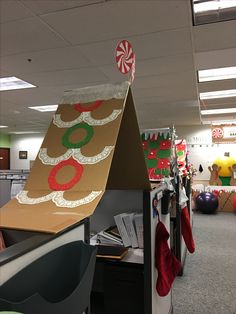 an office cubicle decorated for christmas with candy canes on the top and decorations