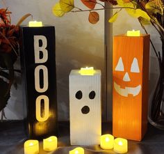 some candles are sitting next to halloween decorations