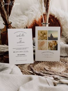 two wedding cards sitting on top of a bed next to each other with feathers in the background