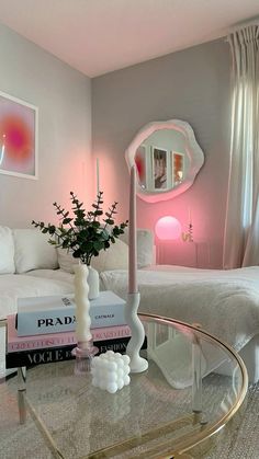 a living room filled with furniture and a glass coffee table in front of a mirror